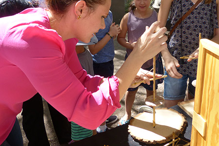 A DVPP staff member demonstrates ancient wooden tools