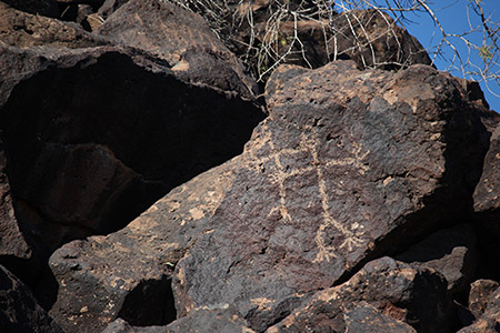 A rock with a petroglyph similar to a stick figure